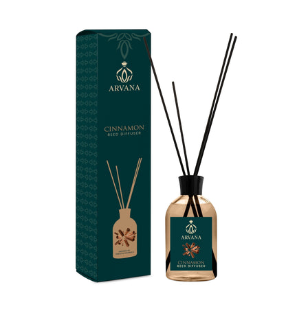 Arvana Cinnamon Reed Diffuser in a clear glass bottle with black reeds and a dark green box.